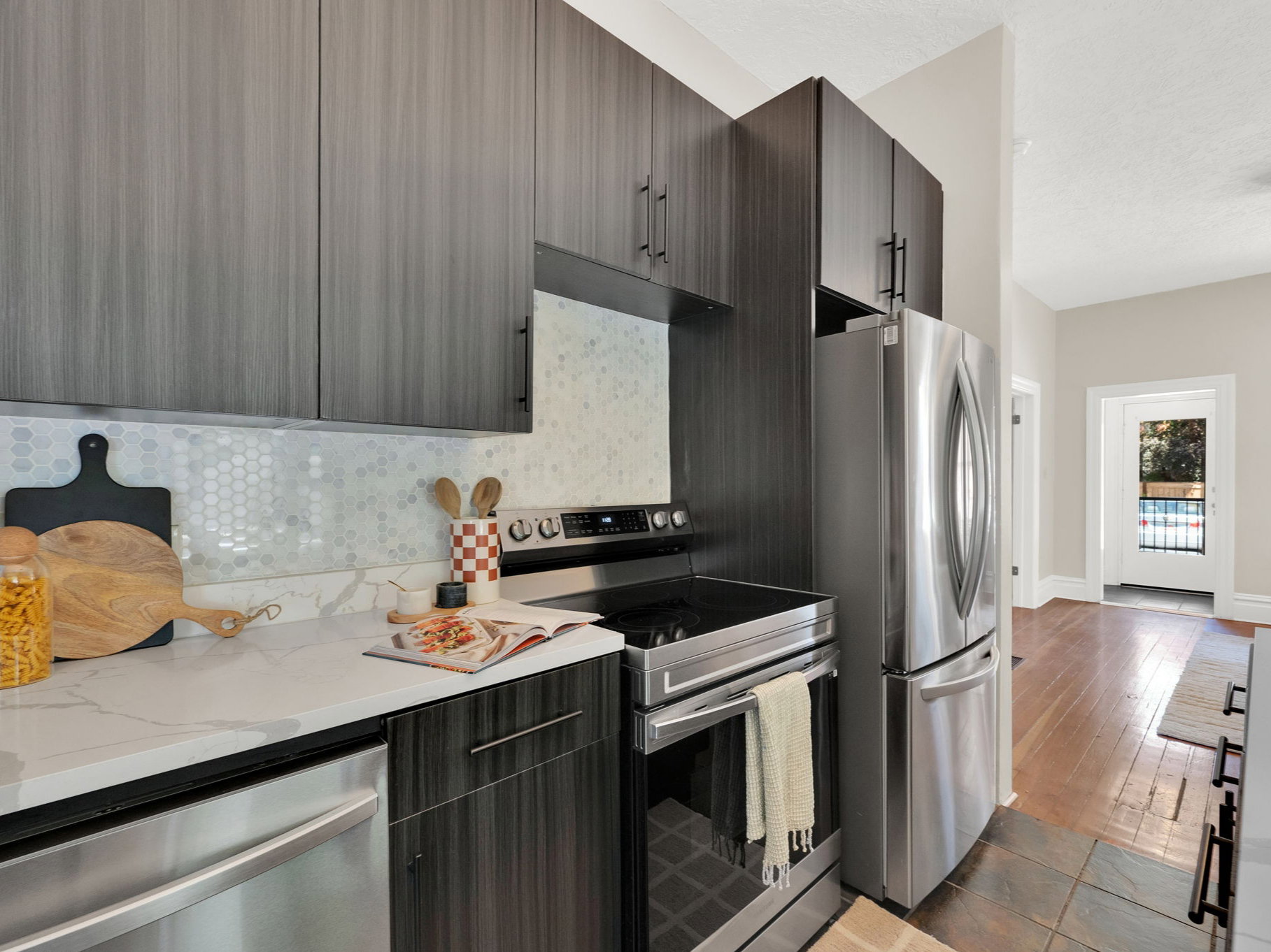Modern kitchen featuring wood-finish cabinetry and stainless steel appliances