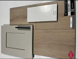Momentum Eagle Mere wood-finish flooring with a long and wide plank design, complemented by a white countertop sample and a light-toned cabinet door with an integrated dark pull
