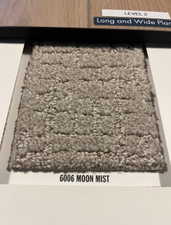 Textured carpet sample in a light grey hue, featuring a raised square pattern