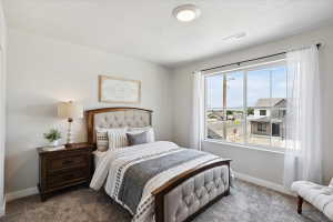 Spacious room featuring a large window, neutral carpeting, and light-toned walls