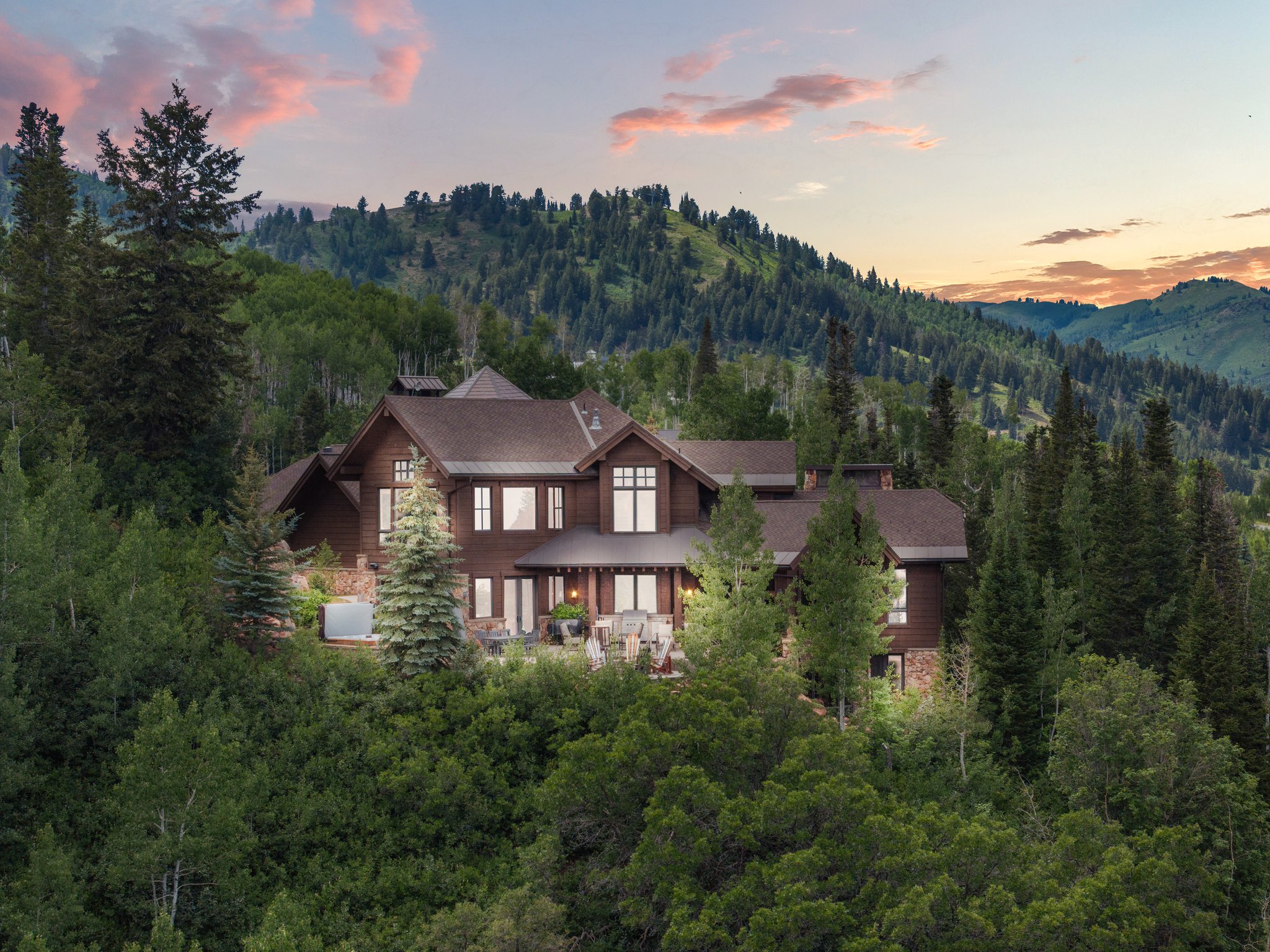 Rustic-modern residence featuring a dark wood facade and stone accents