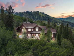 Rustic-modern residence featuring a dark wood facade and stone accents