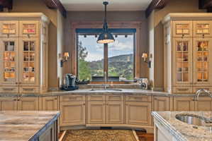 Kitchen featuring a large window with a natural wood frame, offering mountain scenery