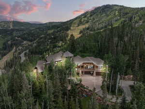 Expansive mountain estate surrounded by dense evergreen and deciduous trees