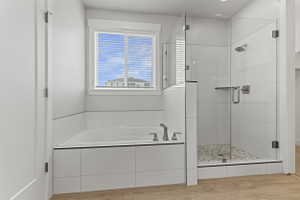 Contemporary bathroom featuring an integrated soaking tub, an expansive glass-enclosed shower with a tiled floor, wood-finish flooring, and a window with blinds