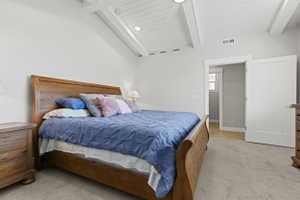 Vaulted white-paneled ceiling with exposed beams, recessed lighting, and a ceiling fan