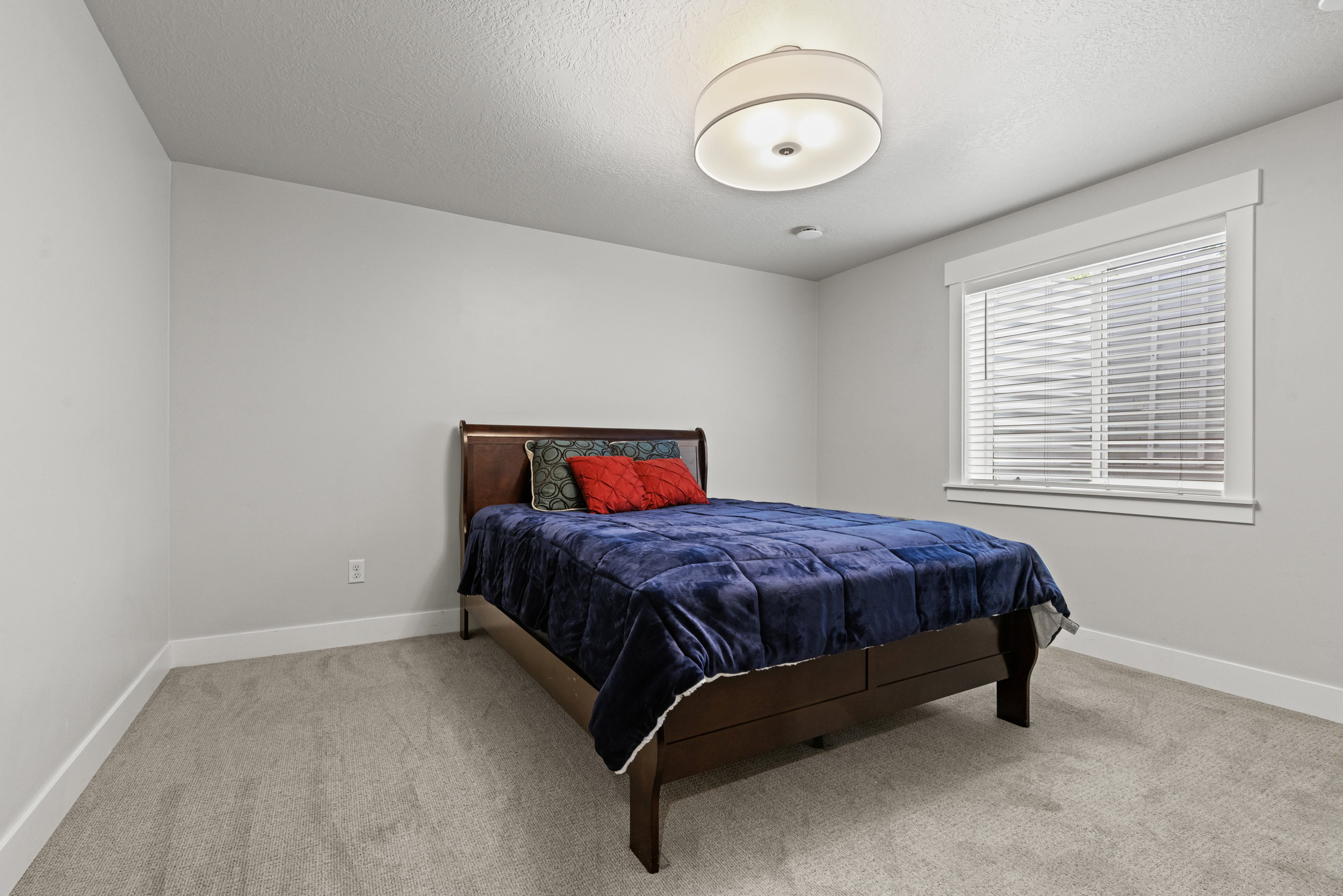 Carpeted room featuring a window with white blinds, a drum pendant light fixture, and recessed lighting