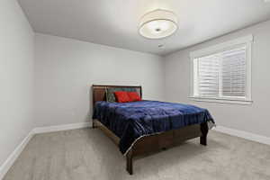 Carpeted room featuring a window with white blinds, a drum pendant light fixture, and recessed lighting