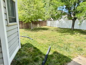 Spacious backyard featuring a mix of wood and vinyl fencing