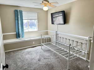 Carpeted room featuring a window with blinds, a window seat, and crown molding