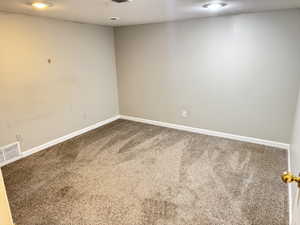 Carpeted room featuring light gray walls, recessed lighting, white baseboards, and a white ceiling