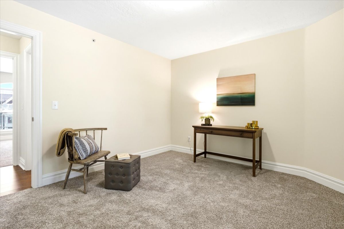Carpeted room with neutral wall color and white trim