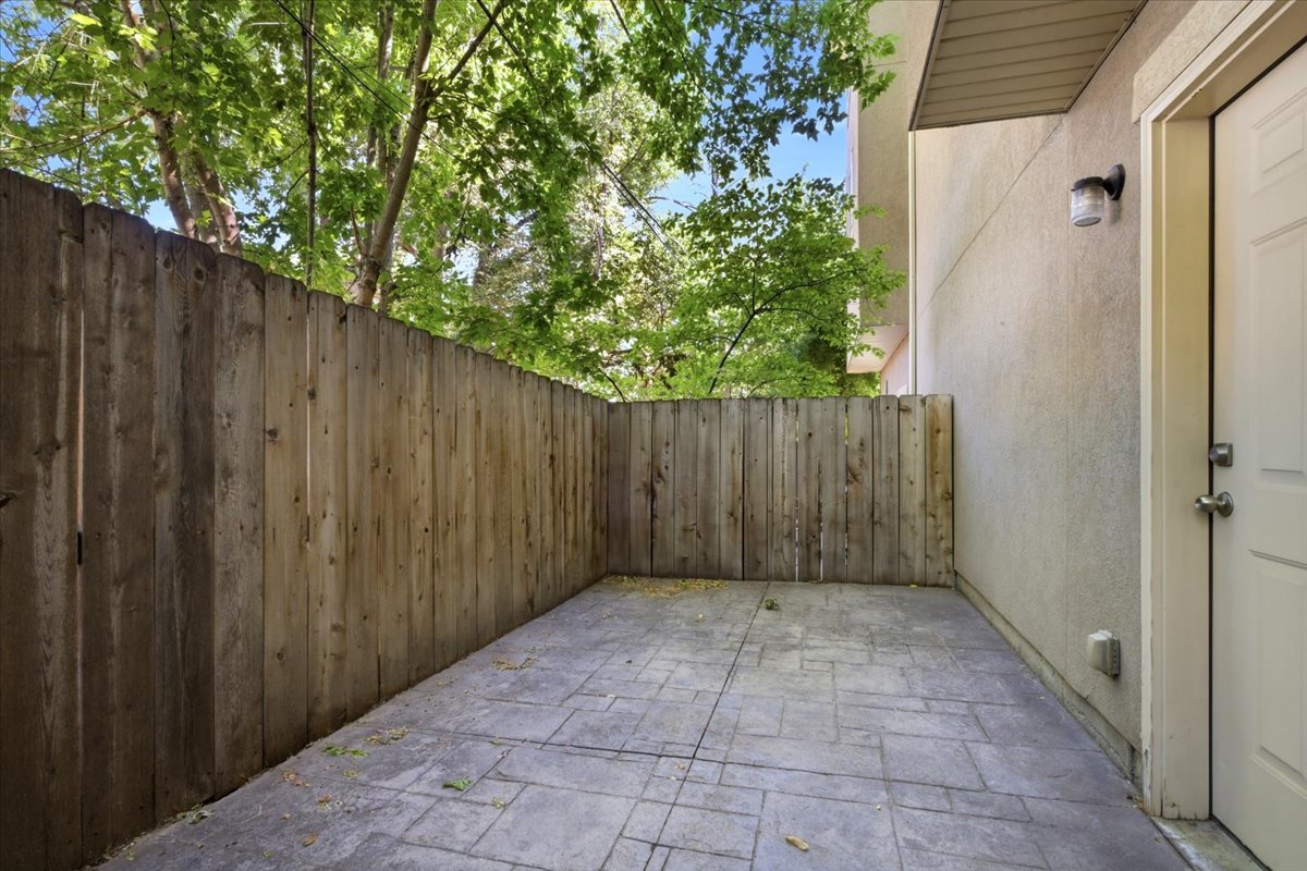 Private outdoor patio featuring stamped concrete flooring