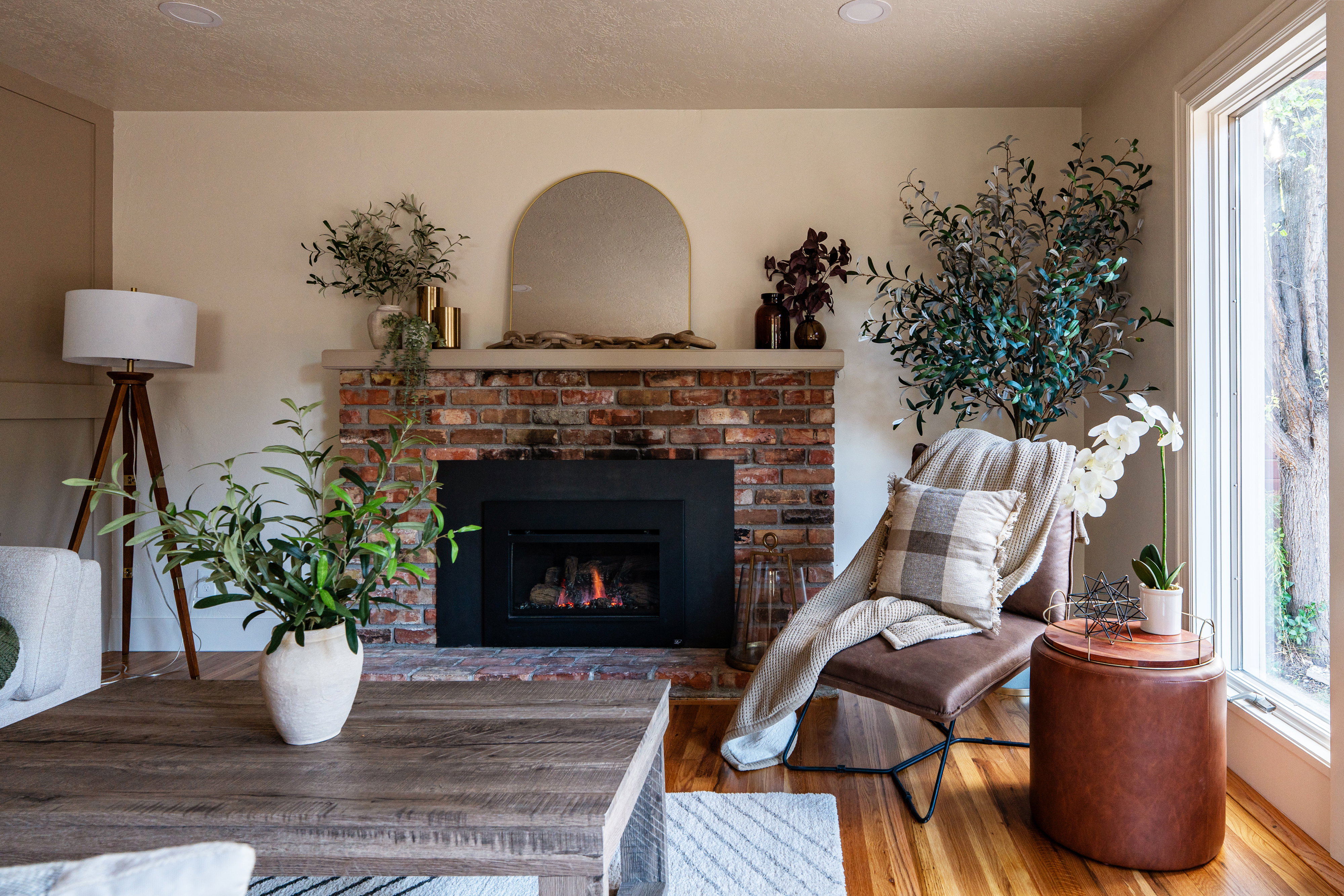 Brick fireplace with a black firebox and a stone mantel