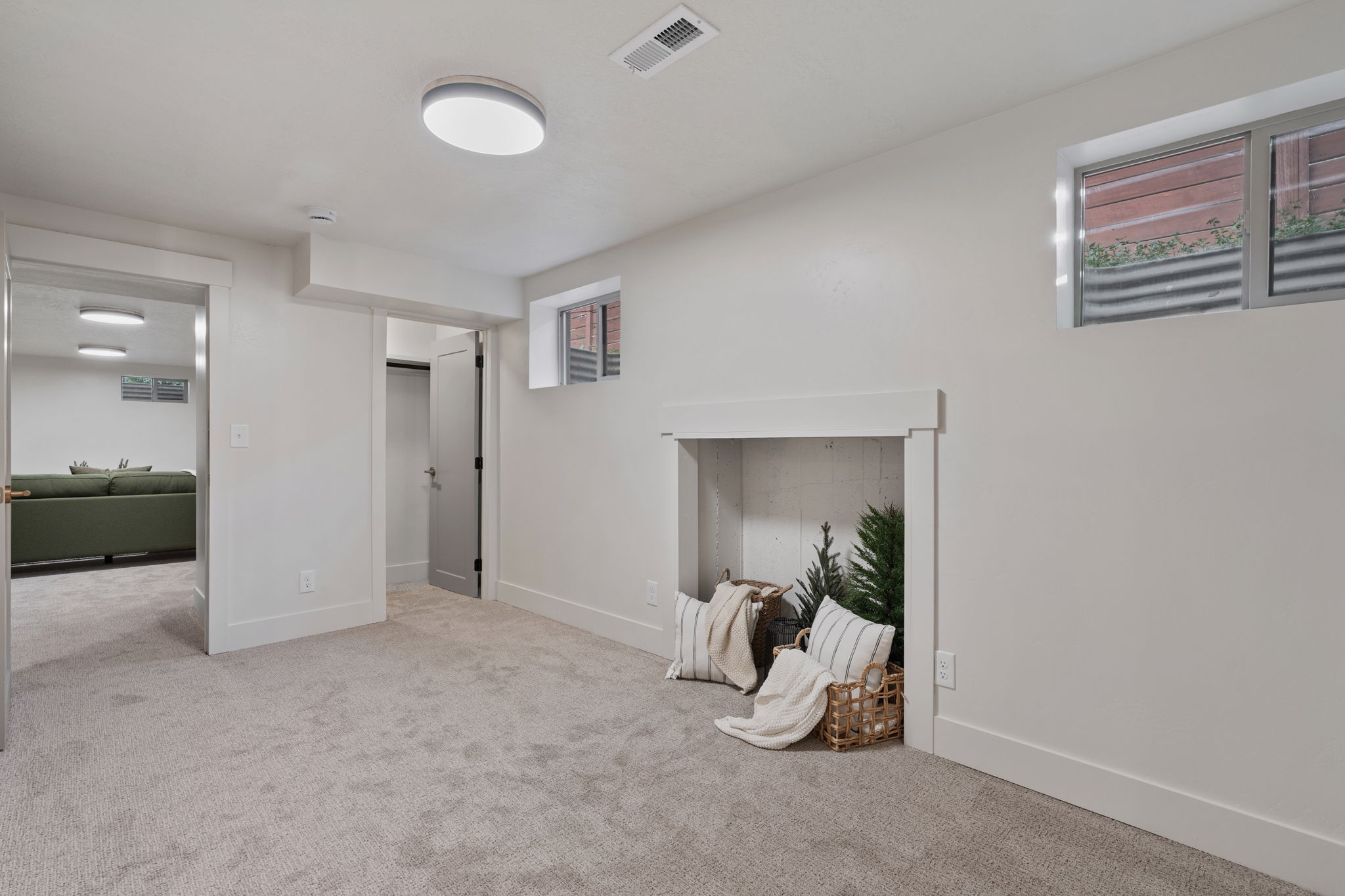 Spacious room with plush carpet flooring and a built-in decorative alcove