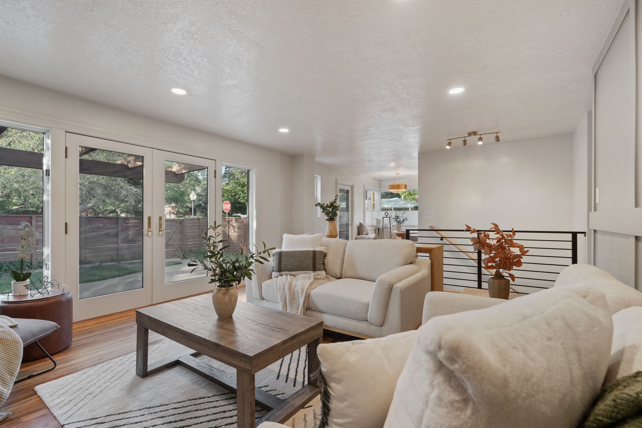 Living area featuring wood-finish flooring and recessed lighting