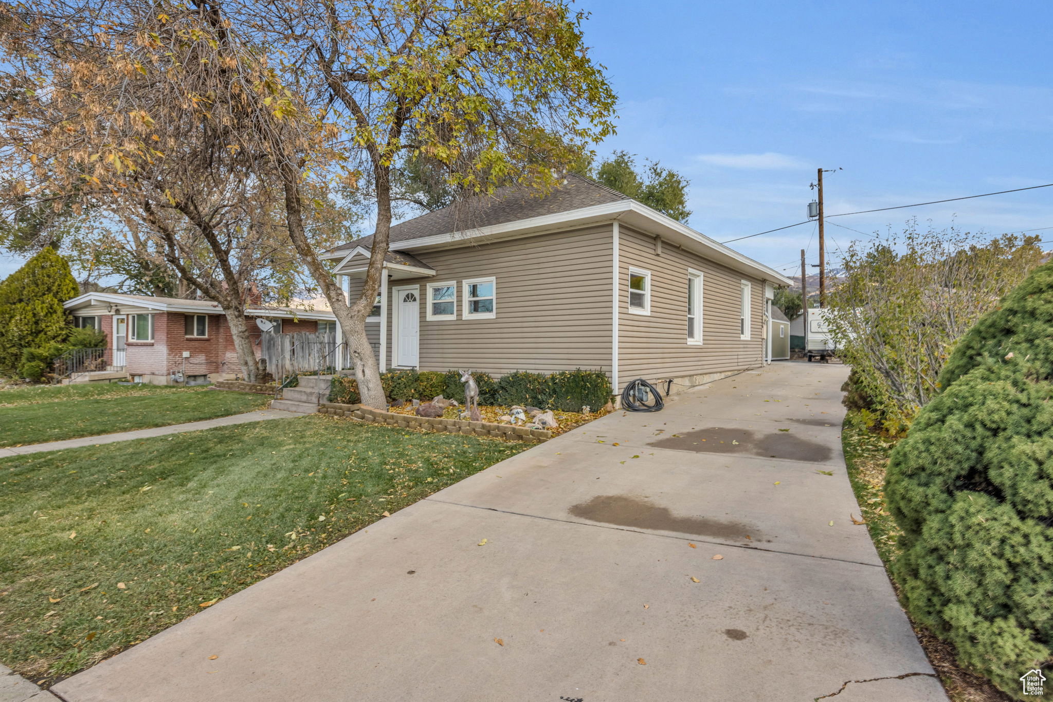 Exterior featuring horizontal siding, a gabled roofline, and a concrete driveway