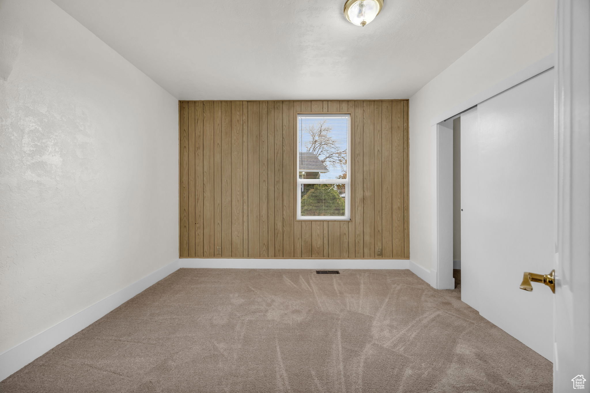 Interior space featuring light-colored carpeting and white baseboards