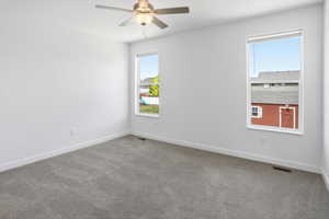 Spacious room featuring neutral carpeting, white walls, and bright white trim