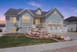 Contemporary exterior featuring light blue siding with white trim accents and a dark shingle roof