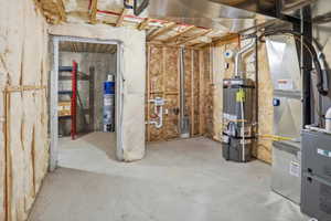 Unfinished basement featuring exposed wood framing, concrete flooring, visible insulation, and essential utility systems
