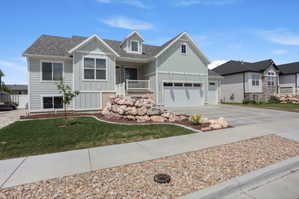 Contemporary two-story residence featuring light green siding and white trim