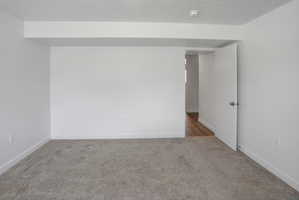 Carpeted interior space featuring white walls and white trim