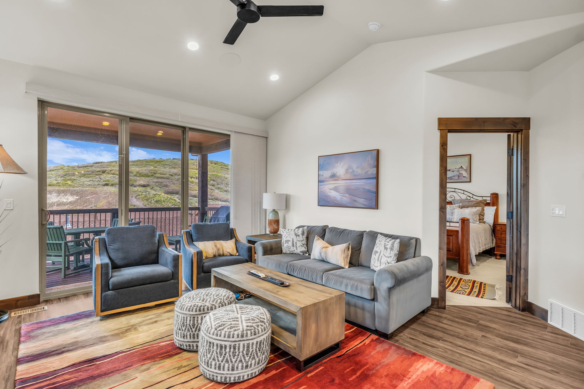 Living area with vaulted ceiling and recessed lighting