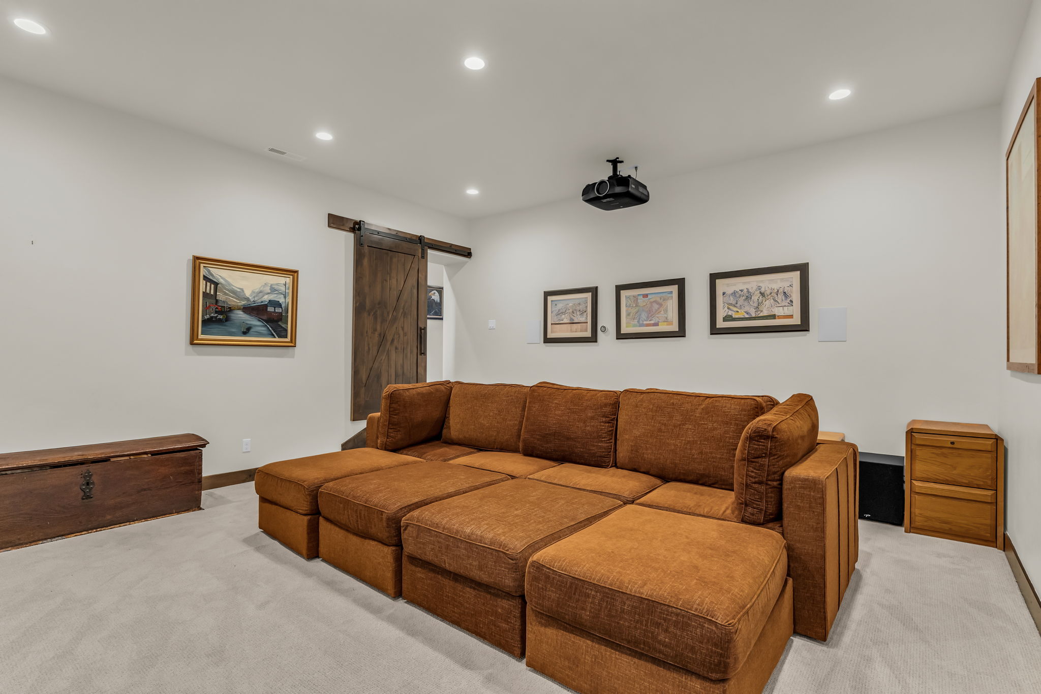 Media room featuring light-colored carpet, recessed lighting, and a ceiling-mounted projector