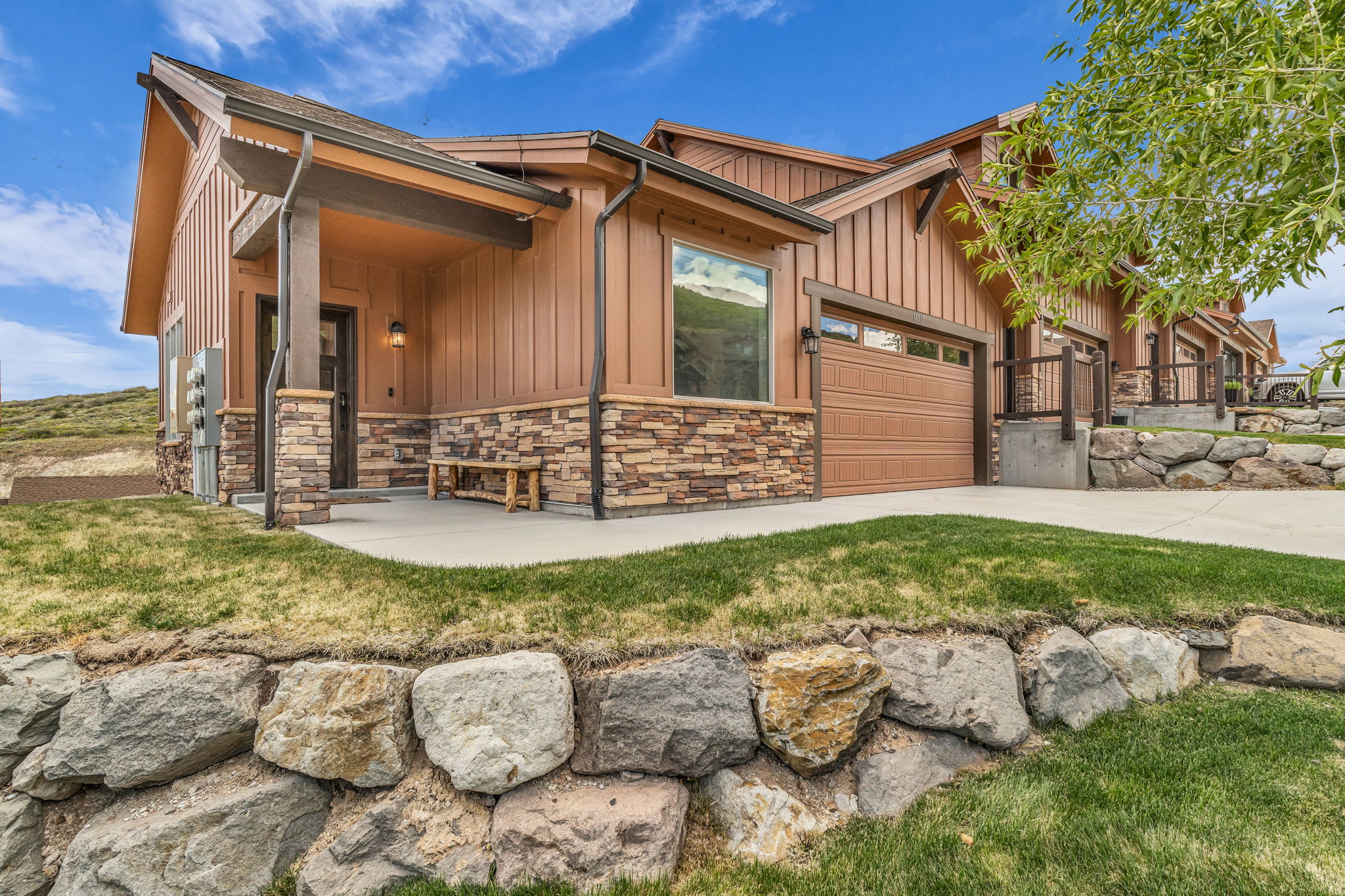 Contemporary exterior with vertical plank siding and stone veneer accents