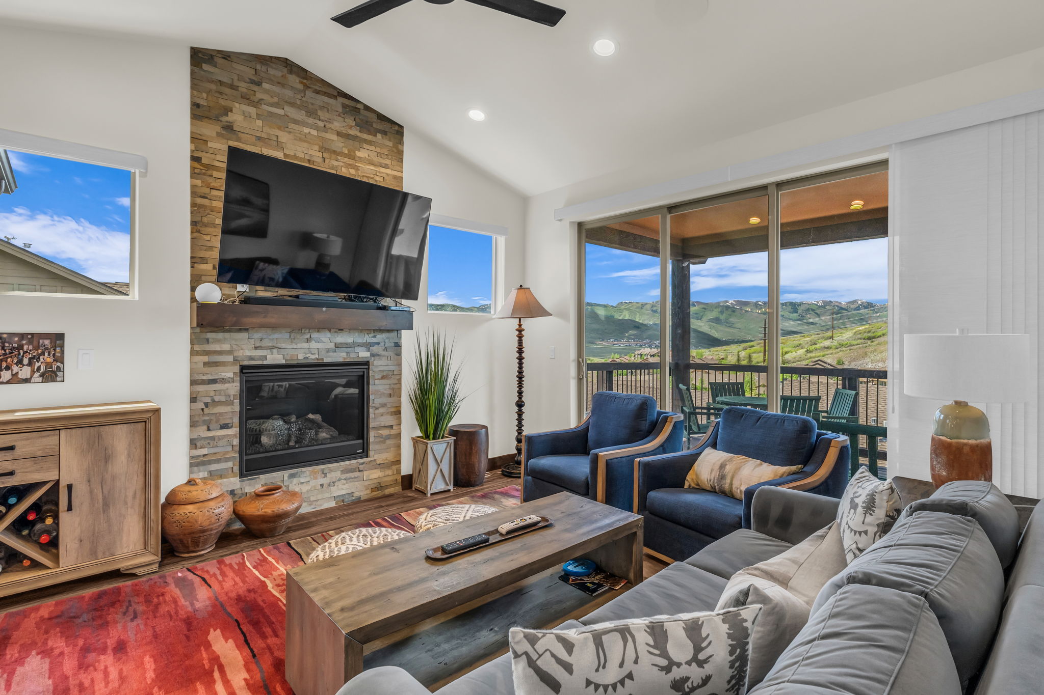 Living area featuring a stone accent wall with a built-in fireplace and wood mantel
