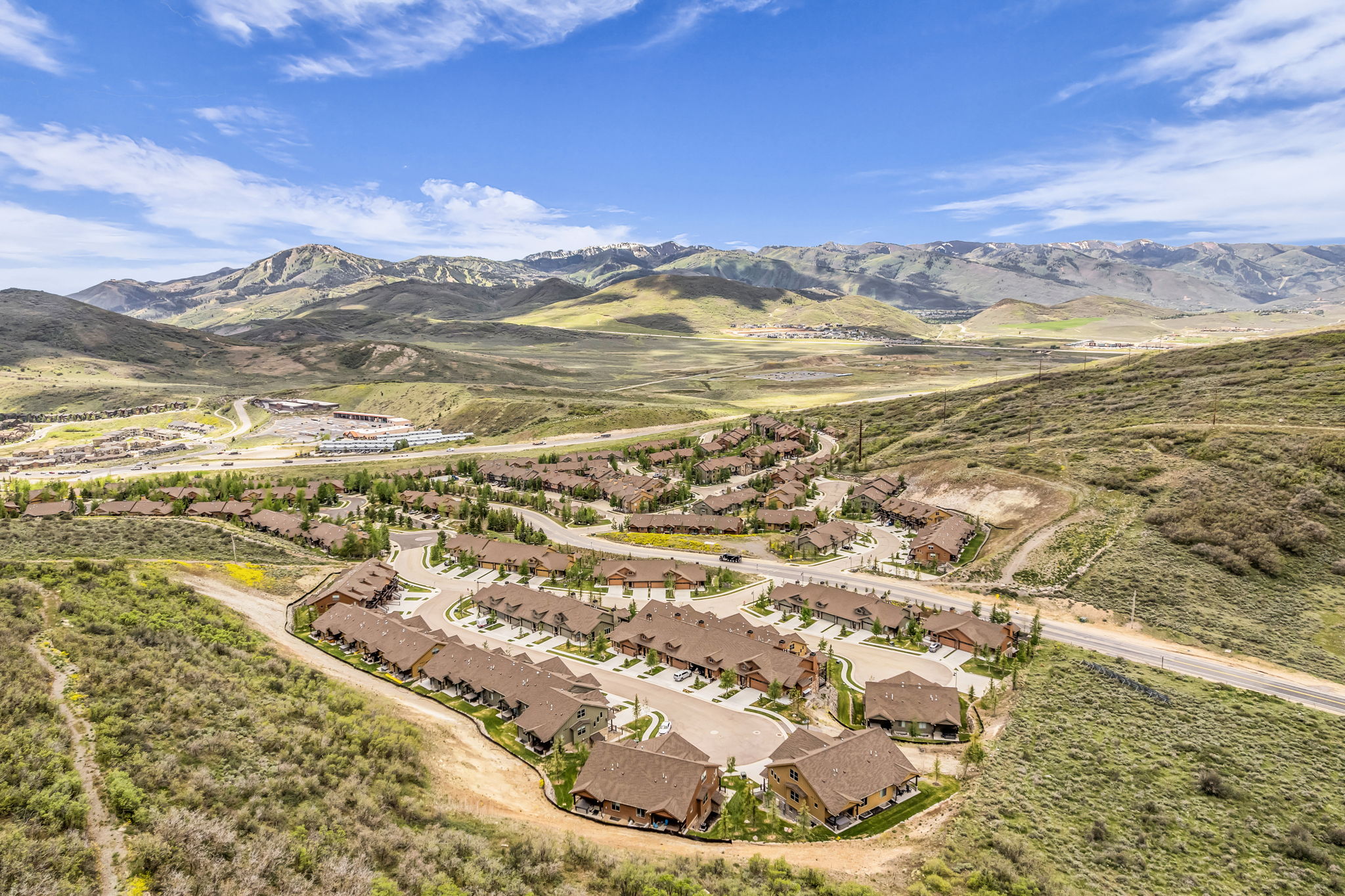 Aerial perspective showcasing a residential community nestled in a mountainous landscape