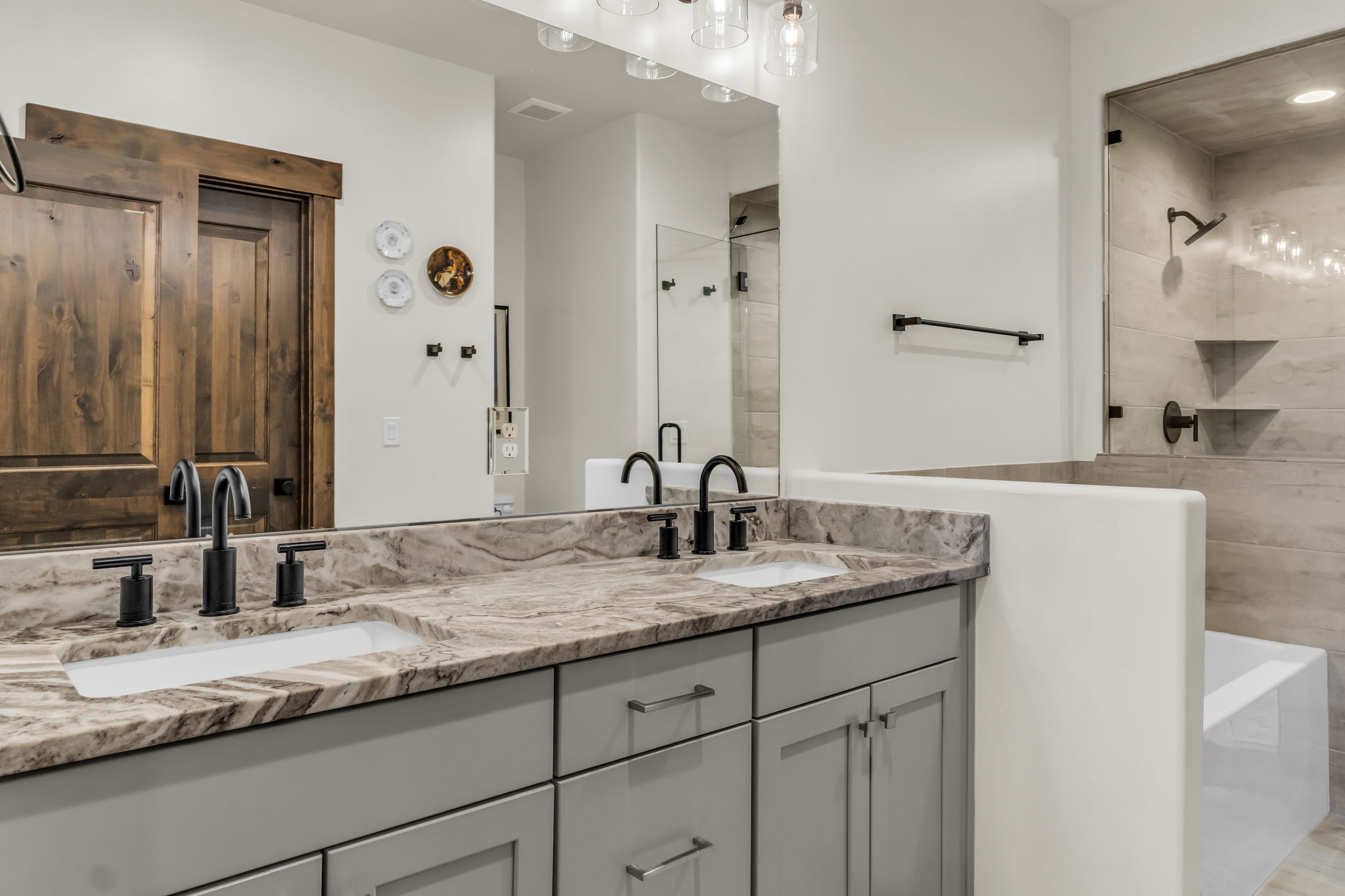 Dual vanity with integrated sinks and dark-toned hardware