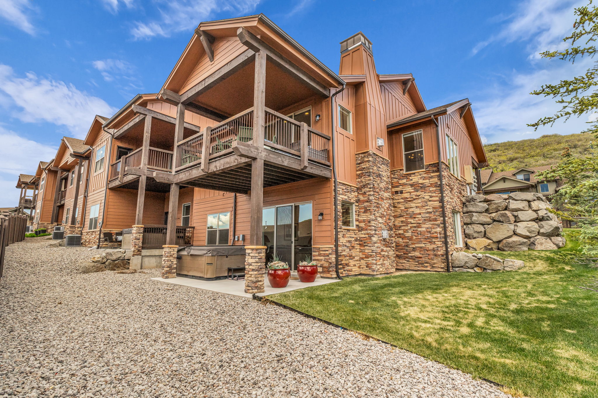 Multi-level property with wood siding and stone accents