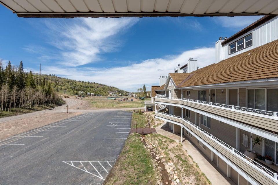 Multi-level building exterior featuring multiple balconies with decorative railings and a shingle roof