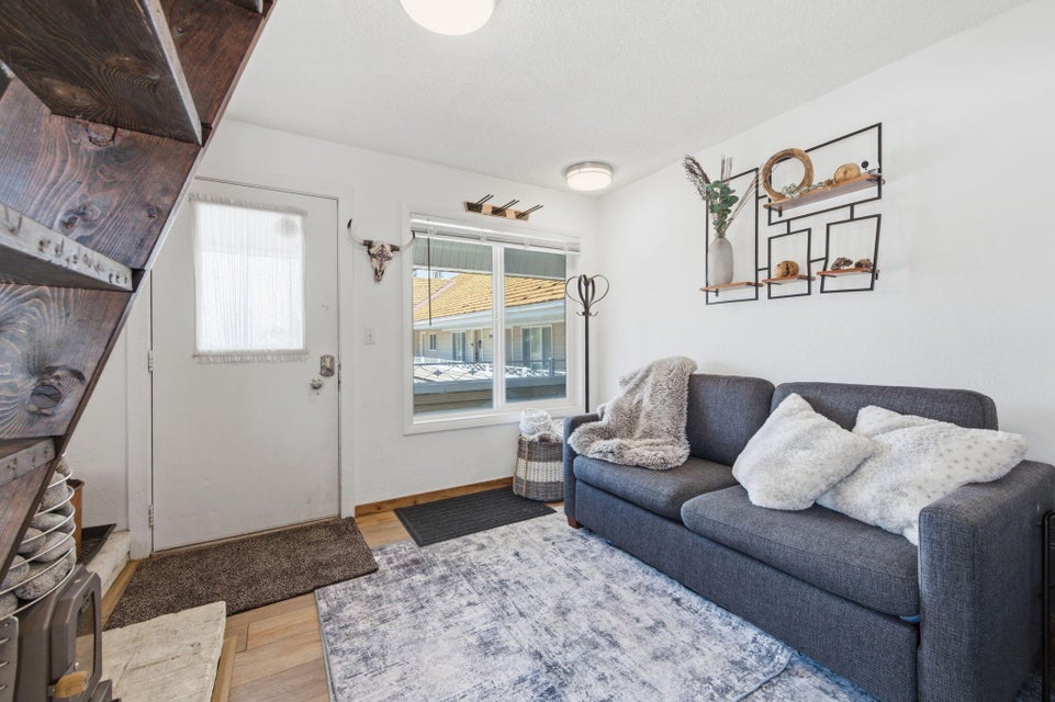 Living area with wood-finish flooring and white walls