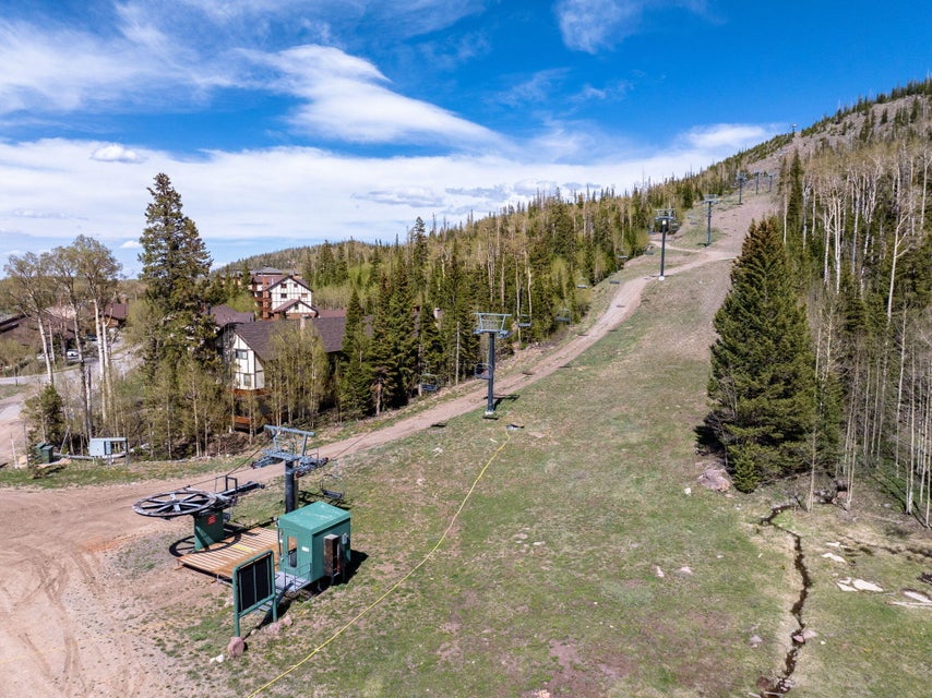 Mountainous terrain featuring a ski lift system and multiple residential structures