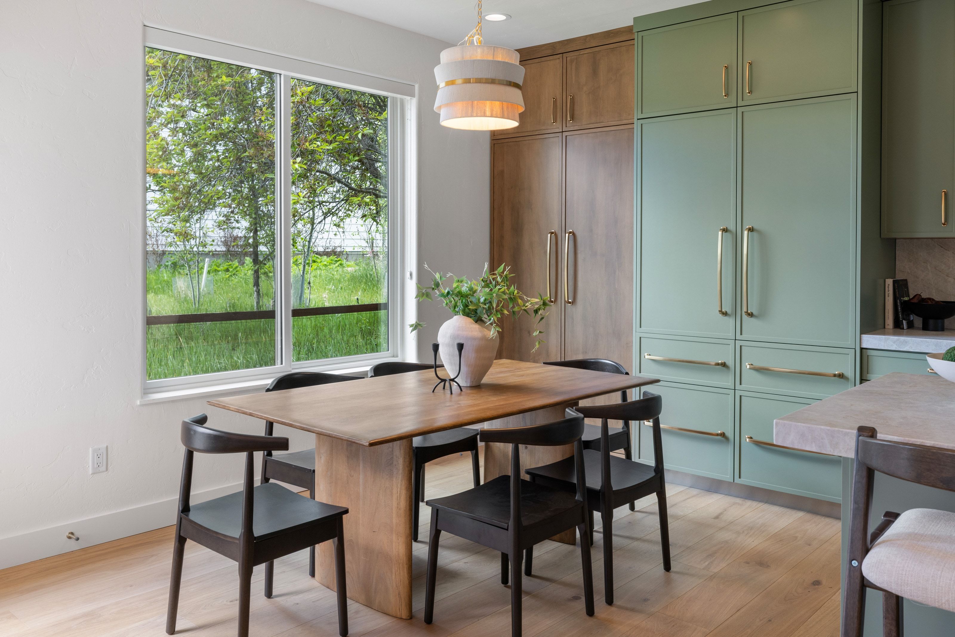 Dining area featuring light wood-finish flooring and a large window