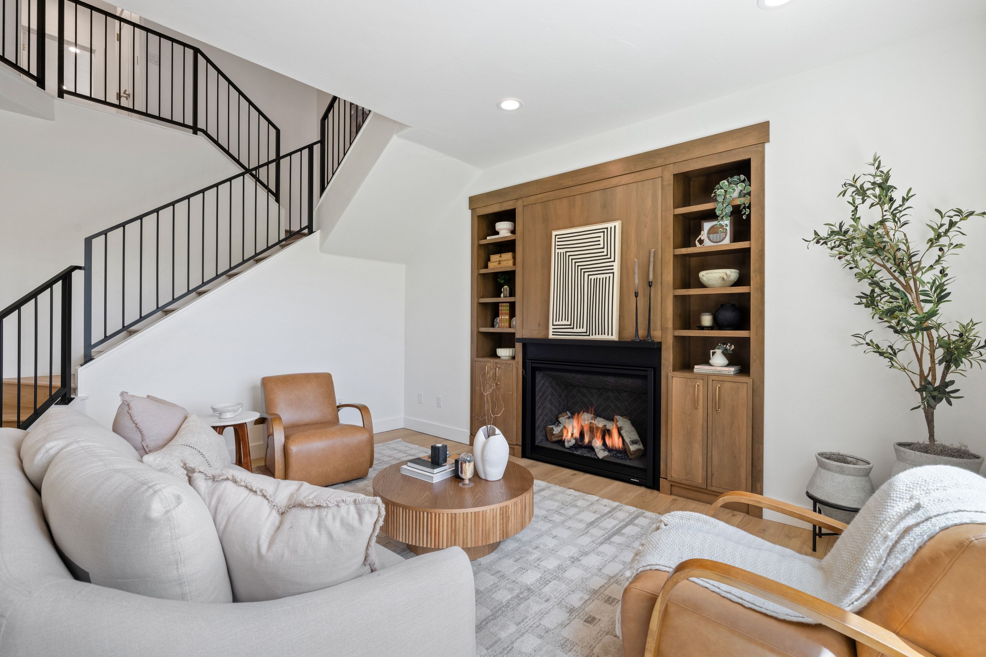 Living area featuring a built-in fireplace with integrated shelving and cabinetry