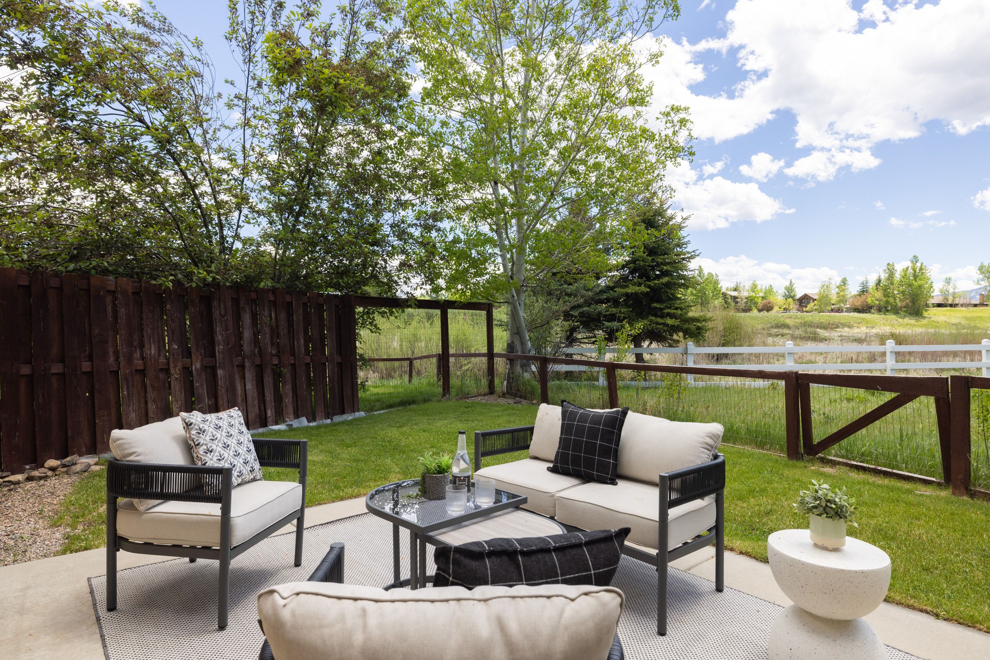 Concrete patio with a woven area rug