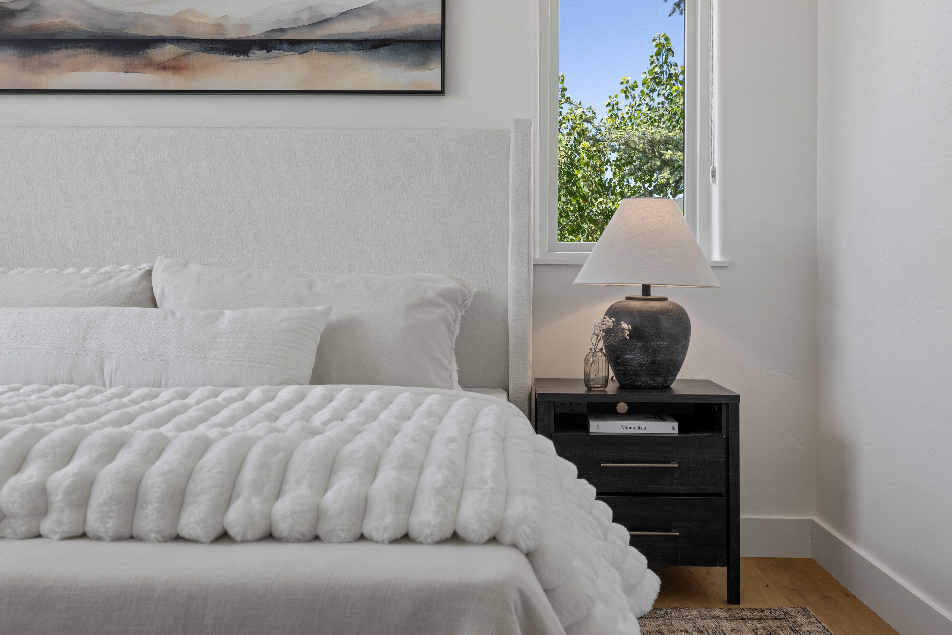 White upholstered headboard with a minimalist design