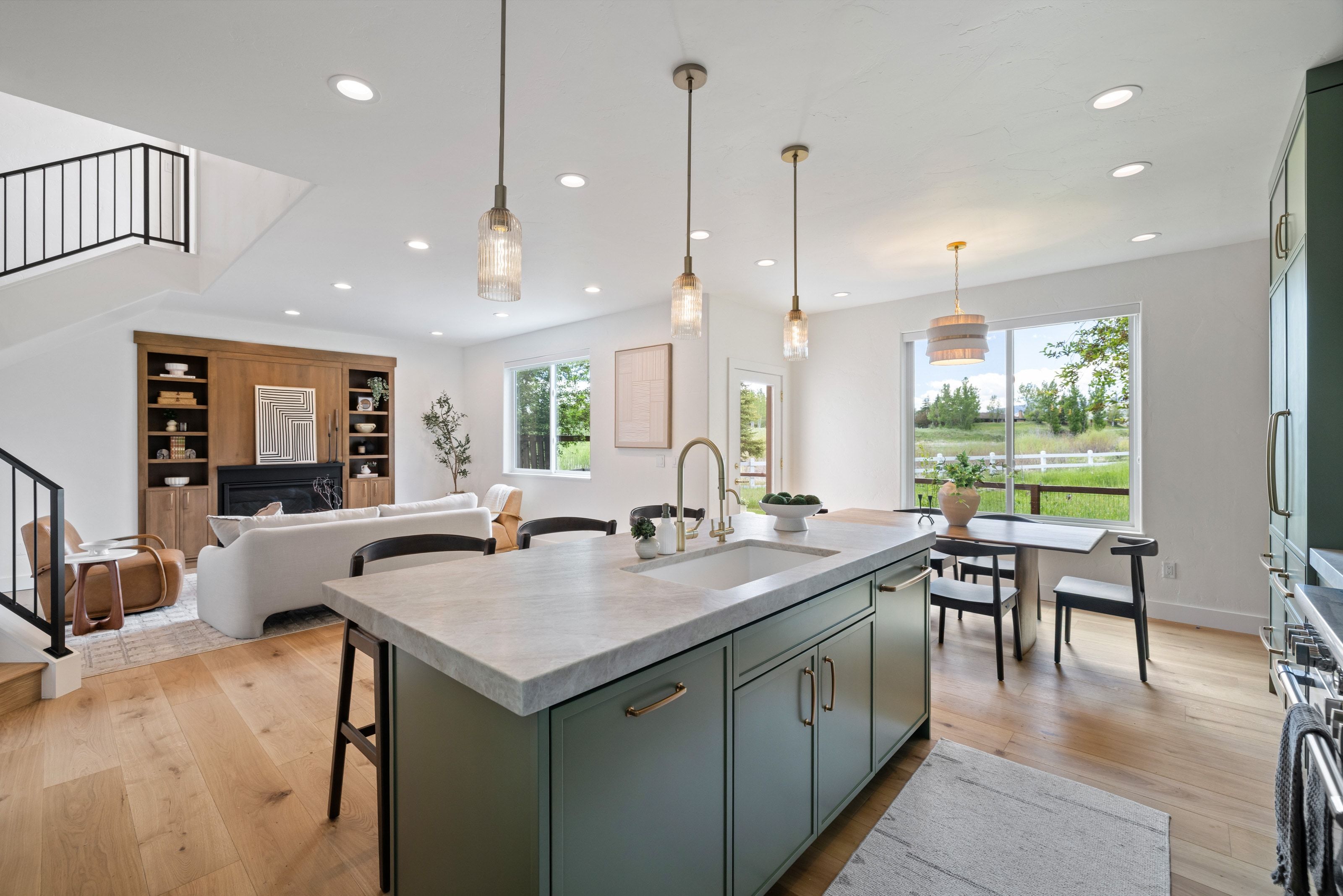Spacious open-concept interior featuring light wood-finish flooring
