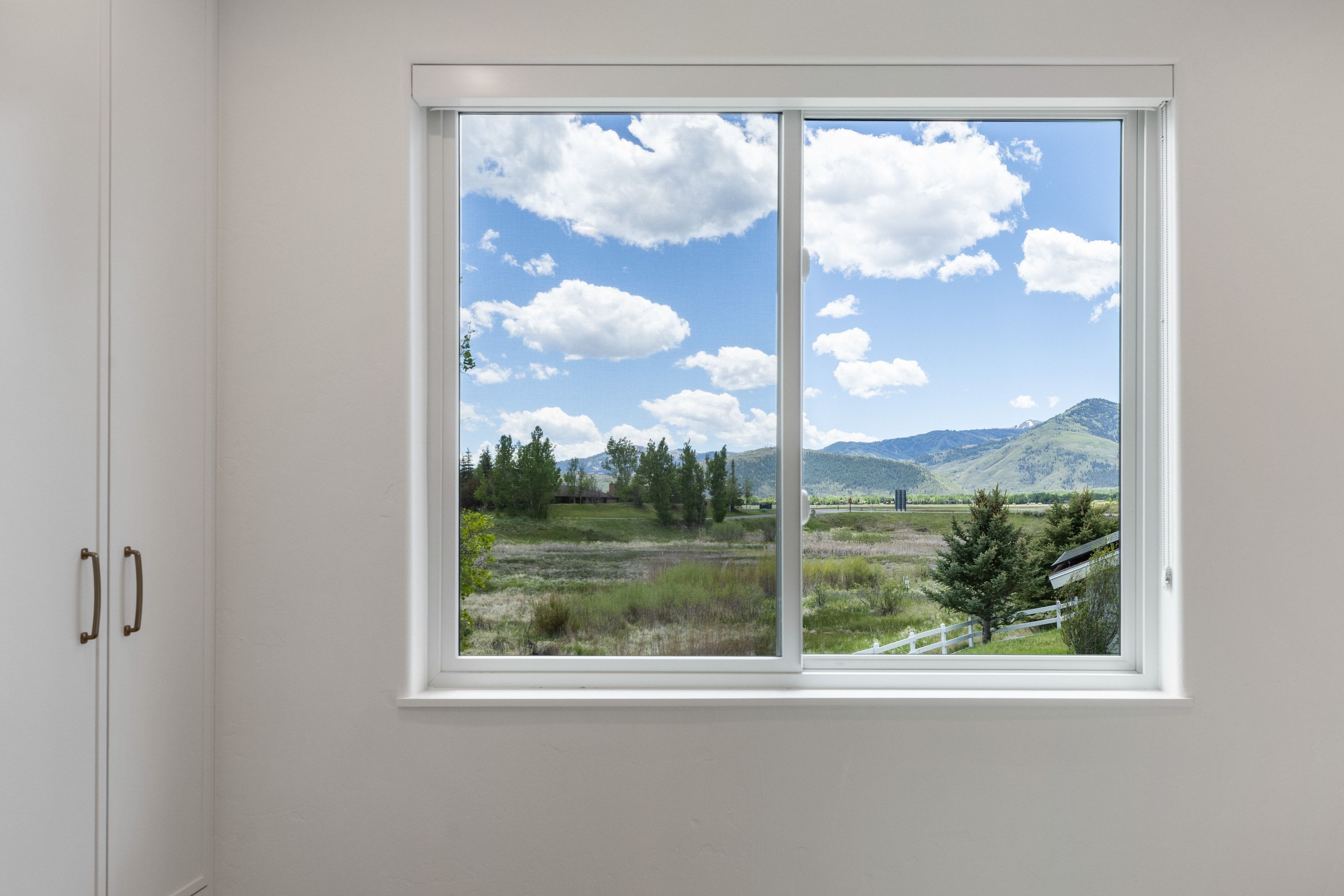 Sliding window framing expansive mountain and landscape scenery