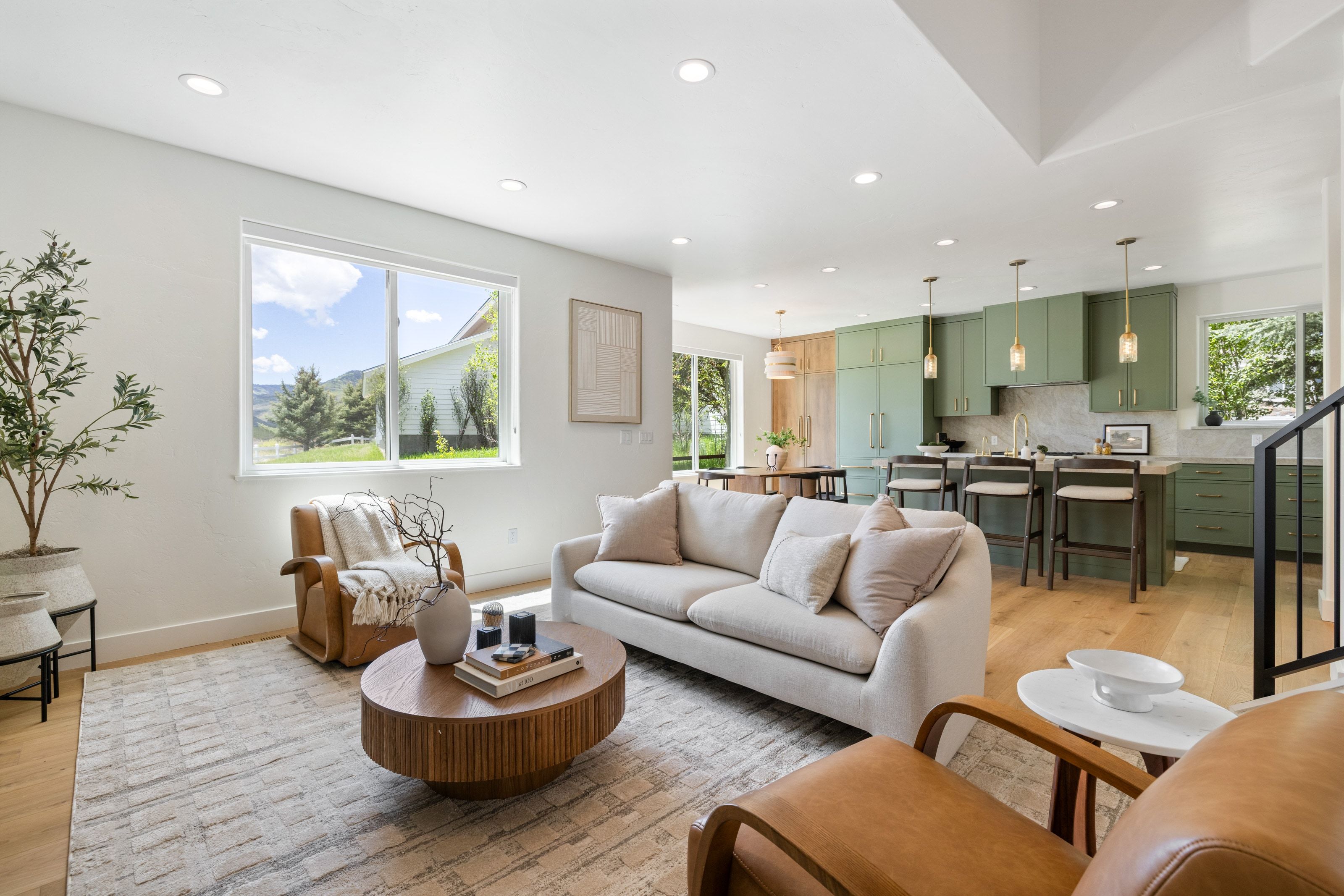 Open-concept living space featuring wood-finish flooring and recessed lighting