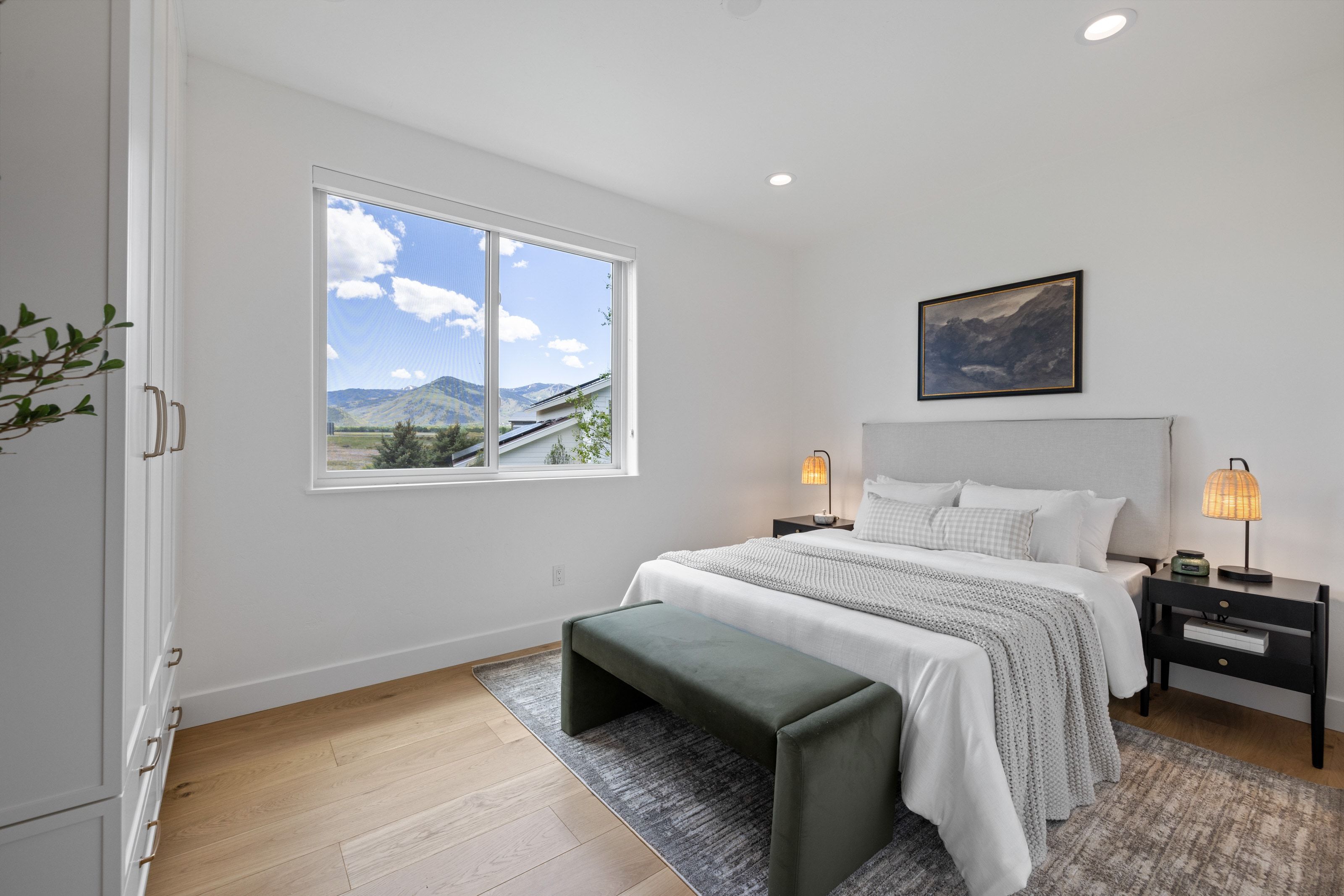 Bright interior space featuring a large window with mountain scenery