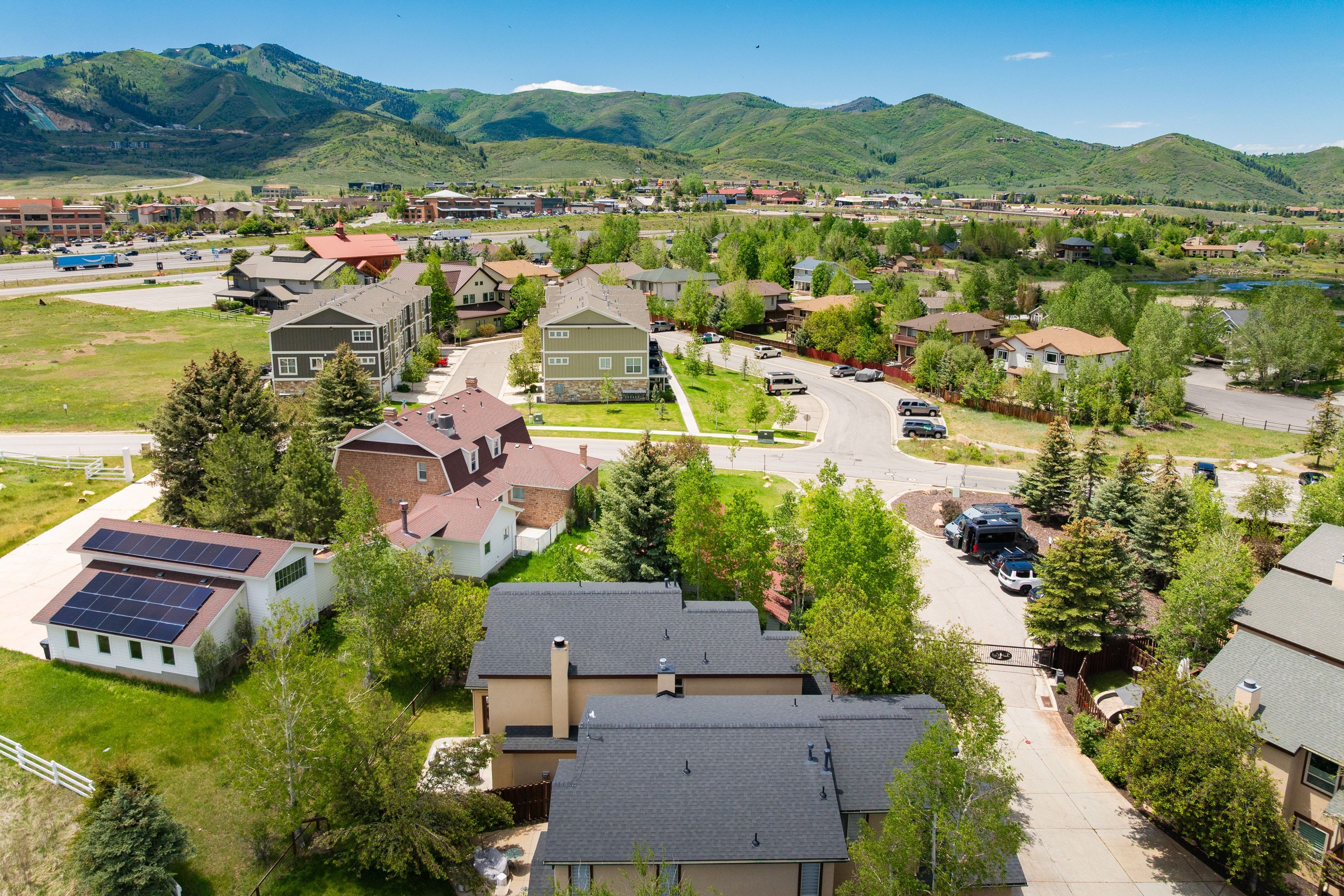 Aerial perspective showcasing residential properties with mountain backdrops