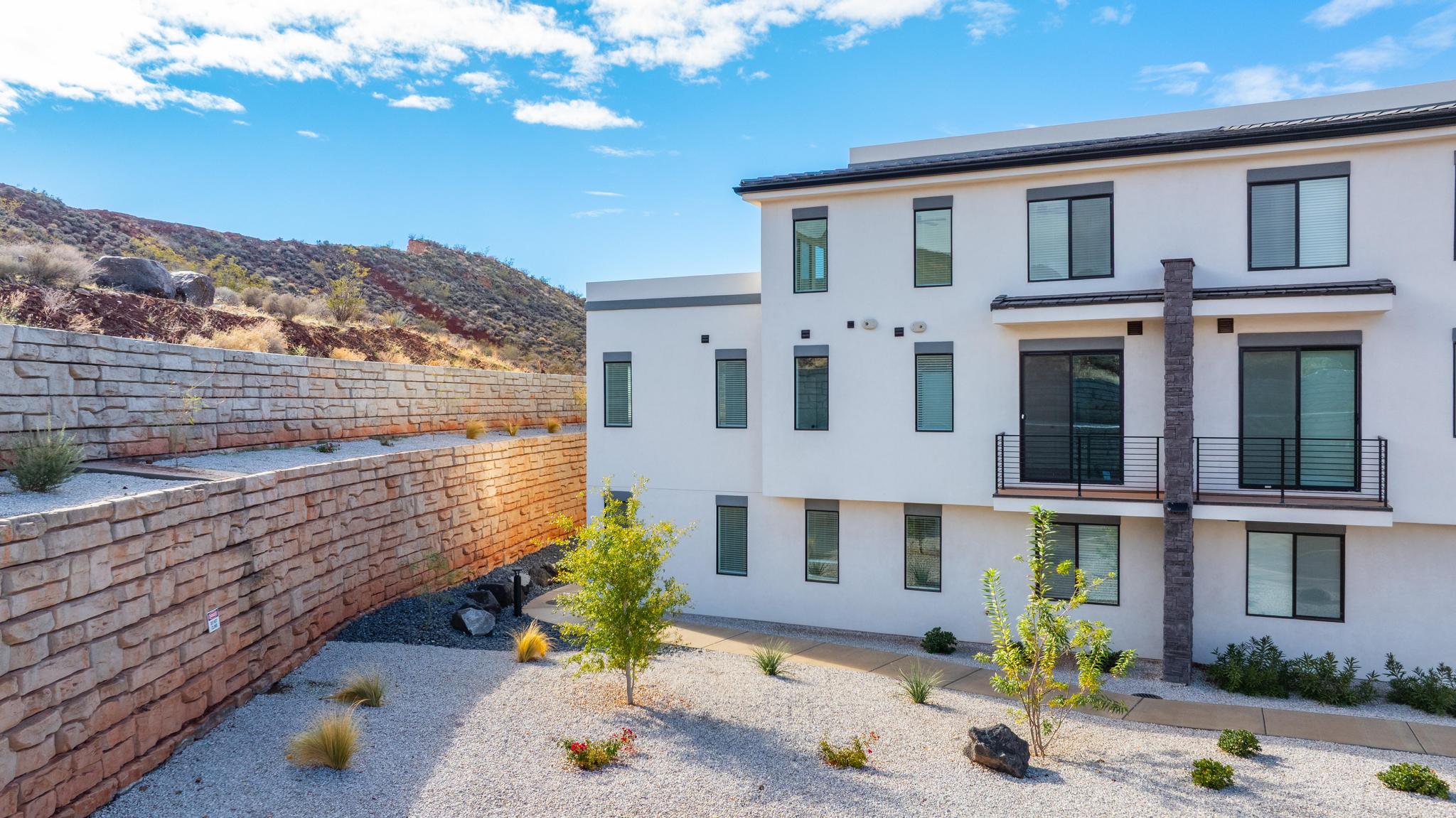 Contemporary exterior with white stucco finish and dark trim accents