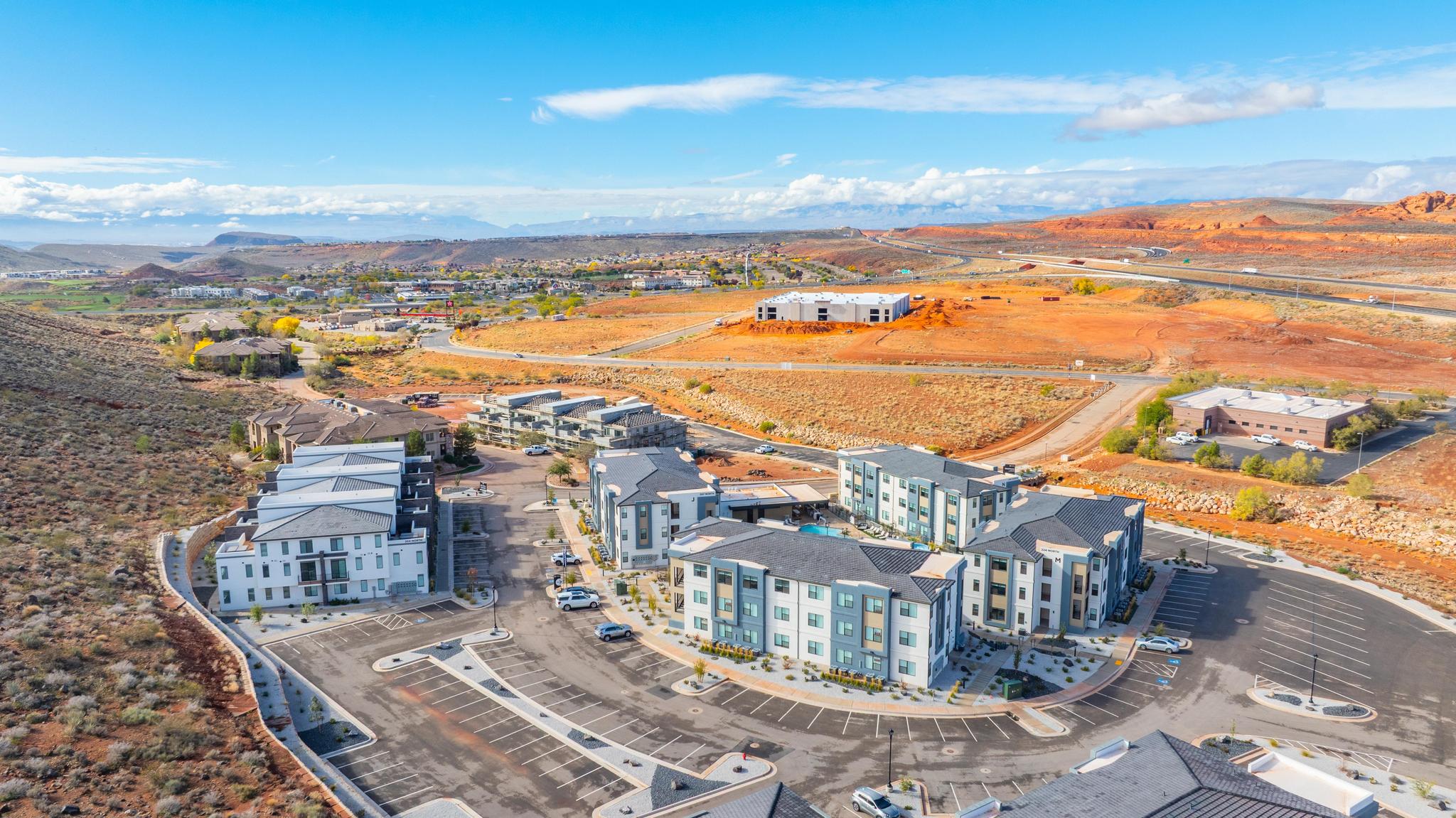 Aerial perspective of a multi-building complex featuring contemporary architectural design