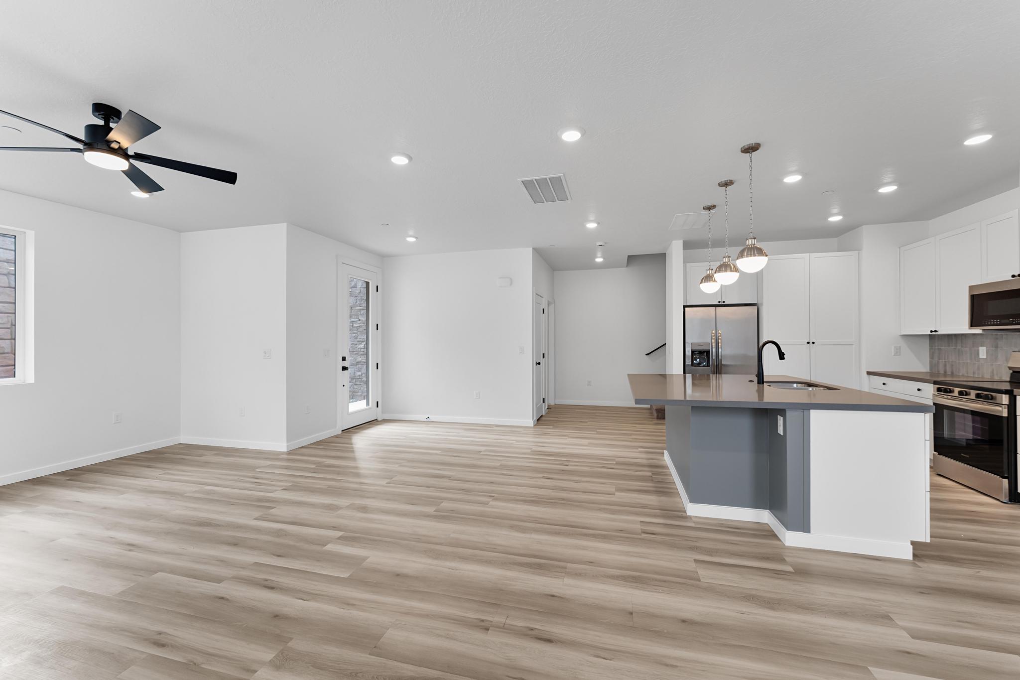 Open-concept living space featuring wood-finish flooring and recessed lighting