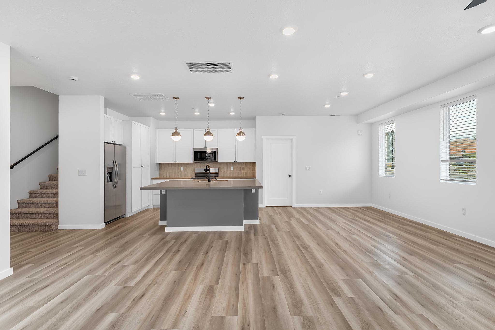 Open-concept living space with wood-finish flooring
